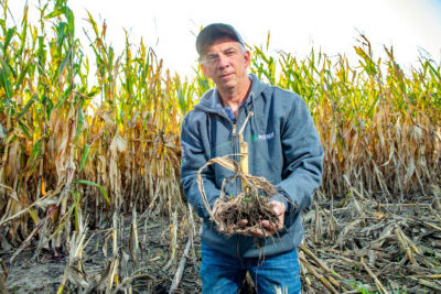 Regen Ag Farmer with corn stalk