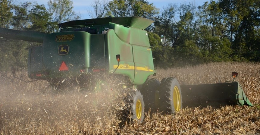 Combine with spreader on field.